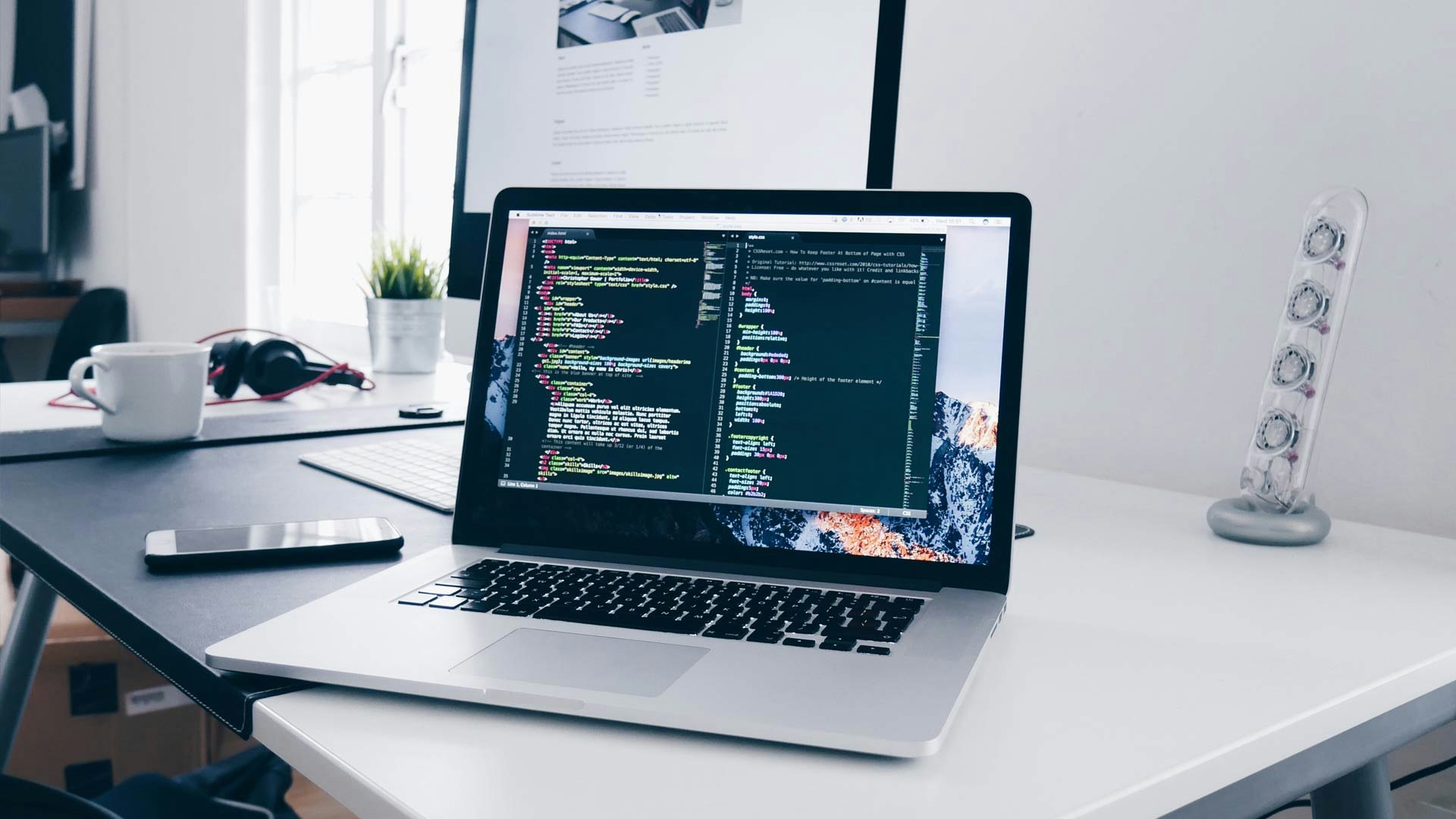 Computer with Code Sitting on Desk